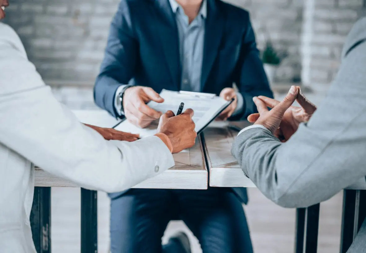 Business meeting with documents and discussion.