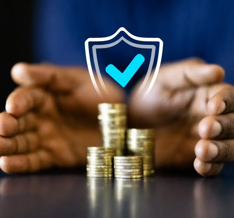 Hands protecting stacked coins with checkmark.